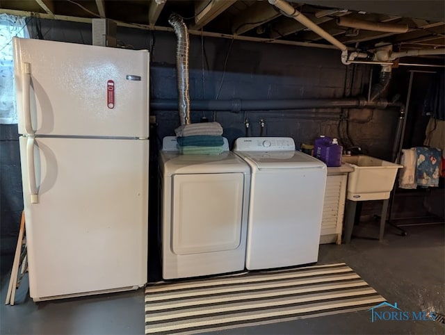 laundry room featuring washing machine and dryer and sink