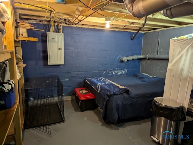 bedroom with electric panel and concrete floors