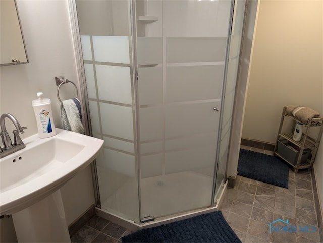 bathroom with sink and an enclosed shower