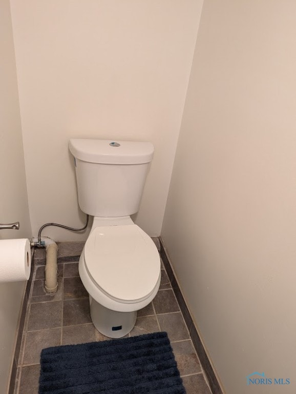 bathroom with tile patterned floors and toilet