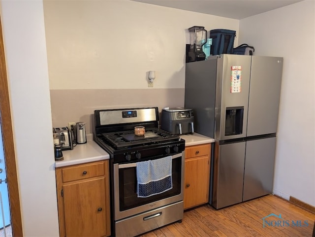 kitchen with light wood-type flooring and stainless steel appliances