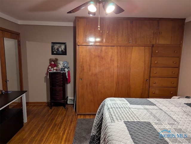 bedroom with dark wood-type flooring, ceiling fan, and a baseboard radiator