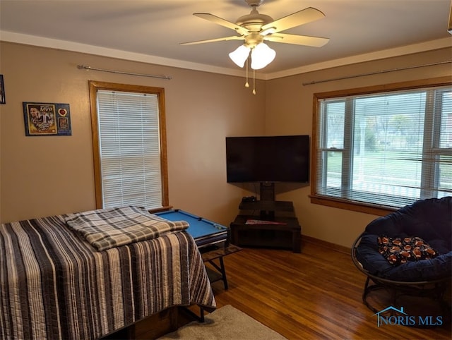 bedroom with hardwood / wood-style floors, billiards, ceiling fan, and crown molding