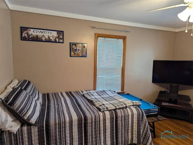 bedroom featuring ornamental molding, dark hardwood / wood-style flooring, and ceiling fan