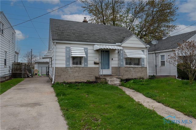 bungalow-style house featuring a front yard