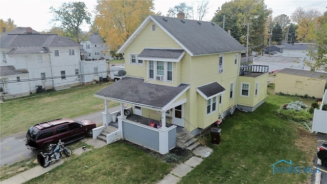 exterior space with a wooden deck and a lawn