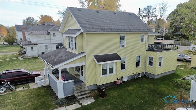 back of house with a wooden deck and a yard