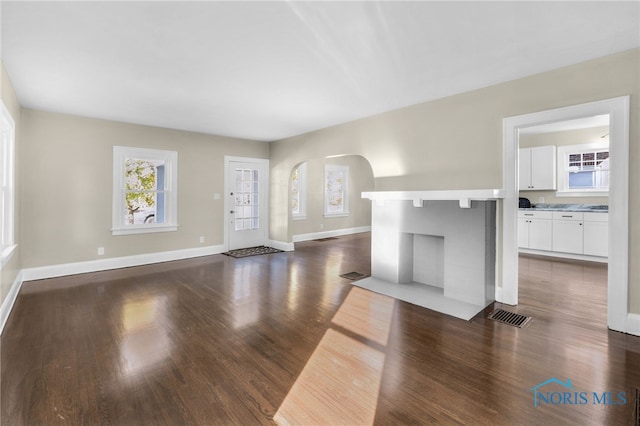 unfurnished living room featuring dark hardwood / wood-style floors