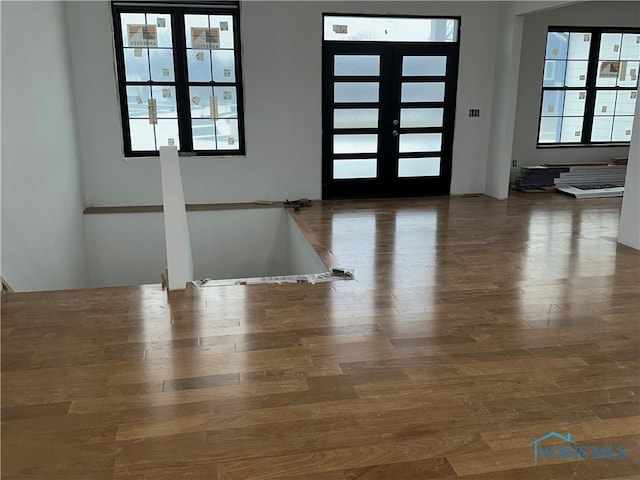 foyer entrance with french doors and dark hardwood / wood-style flooring