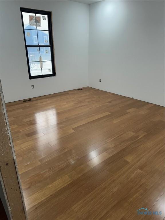 spare room featuring light hardwood / wood-style floors