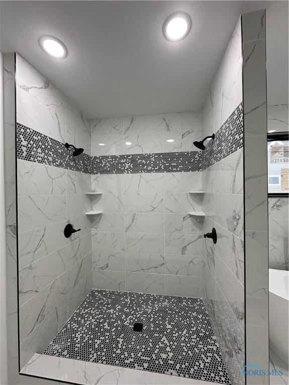 bathroom with tiled shower