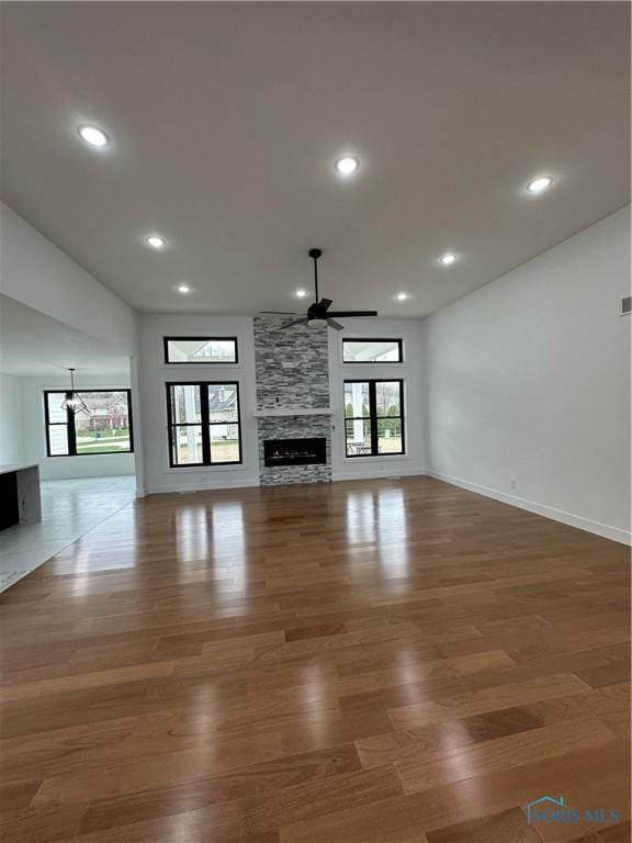 3640 Turtle Creek Dr, Perrysburg, OH 43551 - unfurnished living room with a ceiling fan, wood finished floors, a fireplace, healthy amount of natural light, and recessed lighting