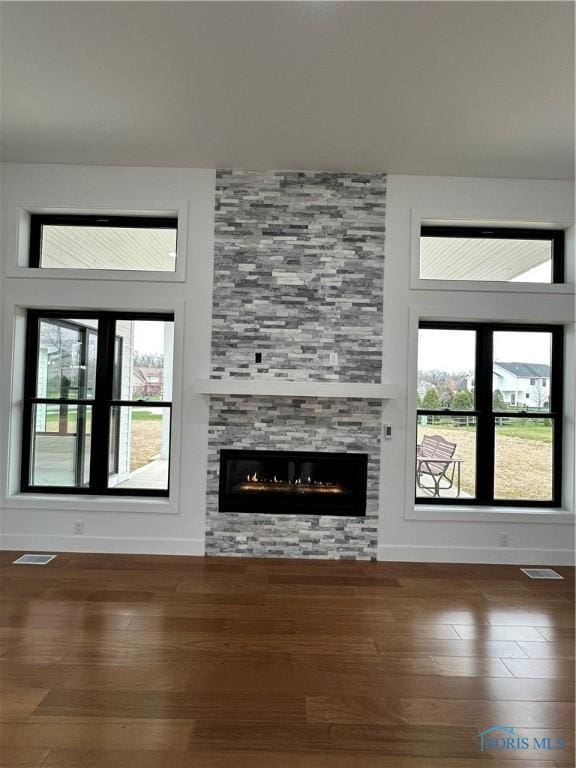 3640 Turtle Creek Dr, Perrysburg, OH 43551 - unfurnished living room with wood finished floors, baseboards, and a large fireplace