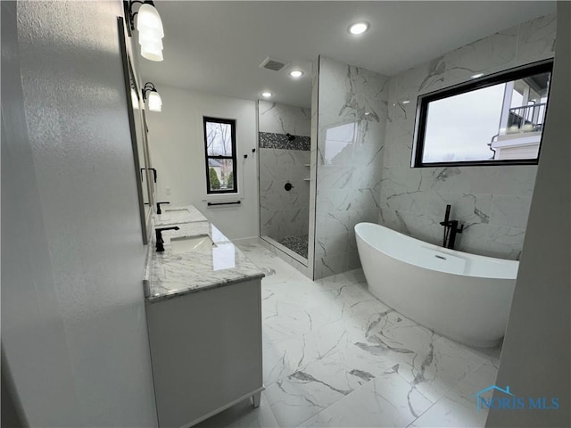 3640 Turtle Creek Dr, Perrysburg, OH 43551 - bathroom with marble tiled floors, a soaking tub, a marble finish shower, double vanity, and recessed lighting