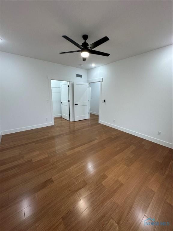 3640 Turtle Creek Dr, Perrysburg, OH 43551 - unfurnished bedroom featuring wood finished floors, baseboards, a ceiling fan, and a spacious closet