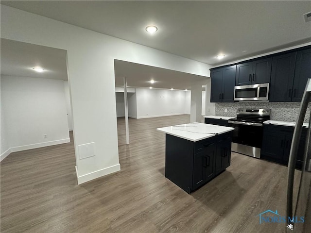 3640 Turtle Creek Dr, Perrysburg, OH 43551 - kitchen with appliances with stainless steel finishes, open floor plan, dark cabinets, baseboards, and recessed lighting