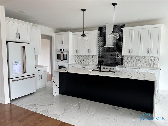 3640 Turtle Creek Dr, Perrysburg, OH 43551 - kitchen featuring high end white fridge, a sink, light marble finish floors, a center island with sink, and pendant lighting