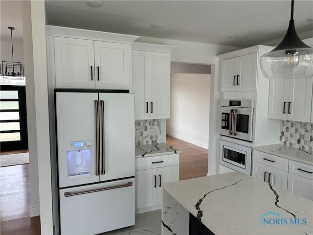3640 Turtle Creek Dr, Perrysburg, OH 43551 - kitchen featuring stainless steel appliances, light stone countertops, tasteful backsplash, white cabinets, and hanging light fixtures