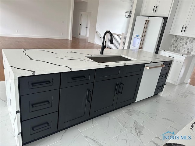 3640 Turtle Creek Dr, Perrysburg, OH 43551 - kitchen with a sink, white appliances, white cabinets, a kitchen island with sink, and light stone countertops
