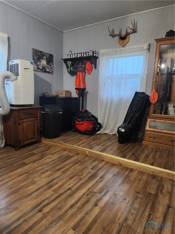 bedroom featuring hardwood / wood-style floors and wood walls