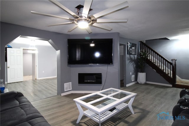 living room featuring hardwood / wood-style flooring and ceiling fan