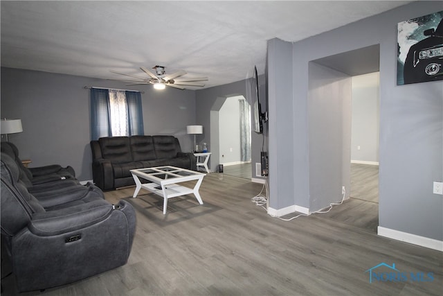 living room with hardwood / wood-style floors and ceiling fan