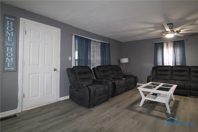 living room featuring hardwood / wood-style floors and ceiling fan