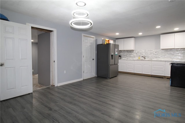 kitchen featuring dark hardwood / wood-style floors, stainless steel fridge with ice dispenser, white cabinetry, and sink