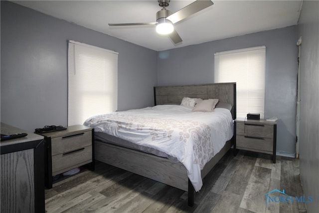 bedroom with dark hardwood / wood-style flooring and ceiling fan