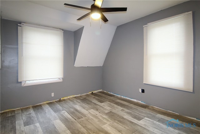 bonus room featuring light hardwood / wood-style floors, vaulted ceiling, and ceiling fan