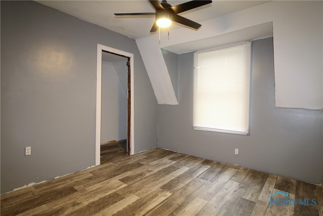 unfurnished bedroom featuring hardwood / wood-style floors, ceiling fan, and a closet