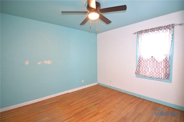 spare room with hardwood / wood-style flooring and ceiling fan