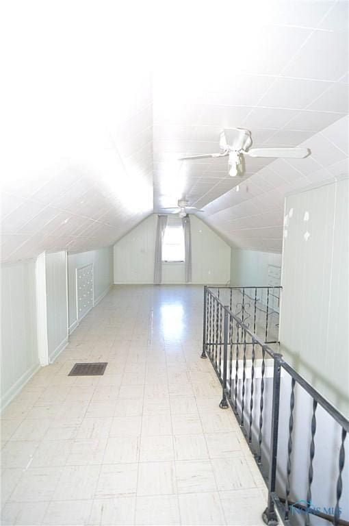 bonus room with lofted ceiling and ceiling fan