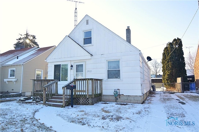 view of snow covered rear of property