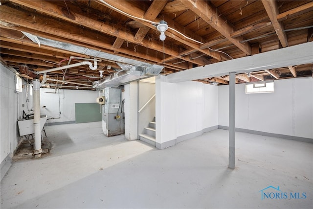 basement with heating unit and sink