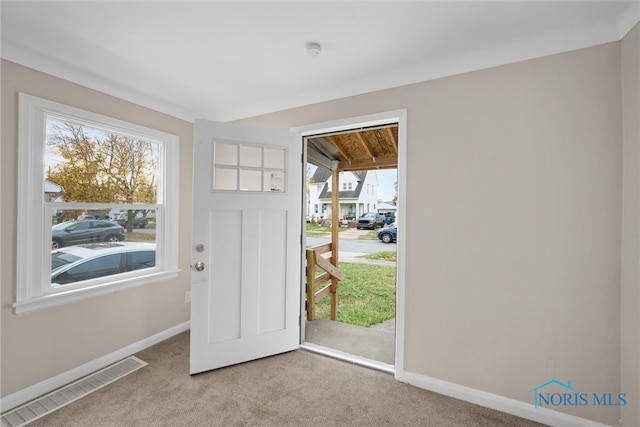 doorway with light colored carpet