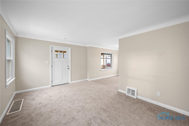 spare room with light colored carpet