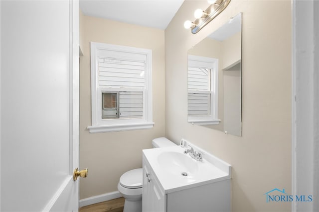 bathroom with vanity, hardwood / wood-style flooring, and toilet