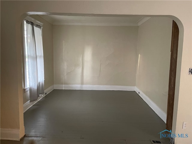 unfurnished room with dark hardwood / wood-style floors and crown molding