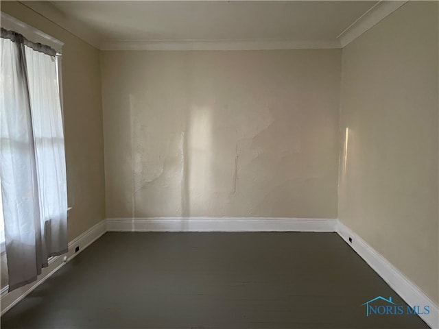 unfurnished room with crown molding