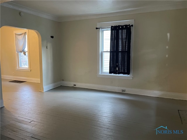 empty room with wood-type flooring and ornamental molding