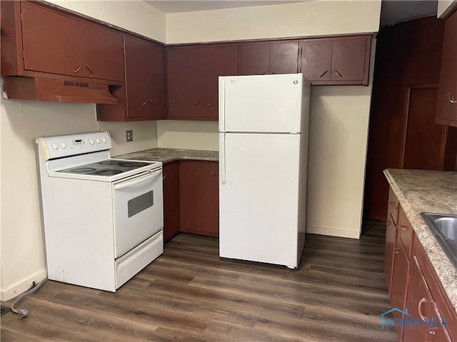 kitchen with dark hardwood / wood-style flooring and white appliances