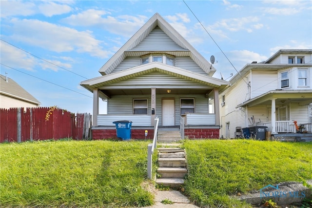 view of front of property with a porch and a front lawn