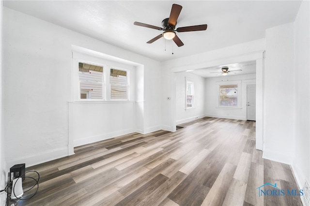 unfurnished living room with hardwood / wood-style floors and ceiling fan