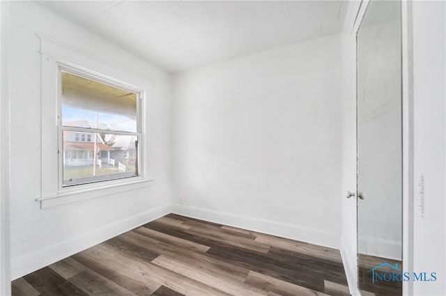 empty room with hardwood / wood-style floors