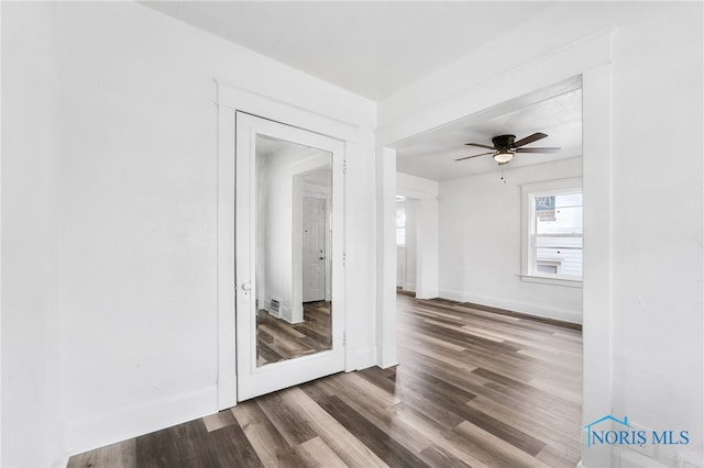 empty room featuring wood-type flooring and ceiling fan