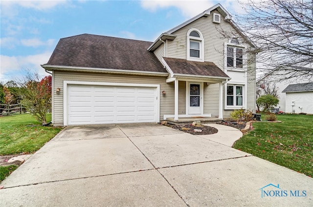 view of property with a front lawn and a garage