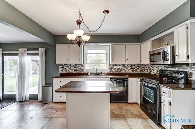 kitchen with black appliances, white cabinetry, an inviting chandelier, sink, and a center island