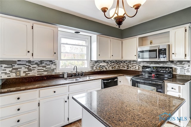 kitchen with white cabinets, appliances with stainless steel finishes, decorative backsplash, and hanging light fixtures