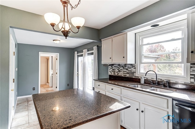 kitchen featuring white cabinetry, a healthy amount of sunlight, and a center island